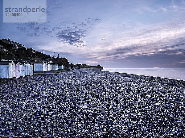 Dämmerungsszene mit Strandhütten und taufrischen glitzernden Kieselsteinen am Strand von Budleigh Salterton  Devon  England  Vereinigtes Königreich