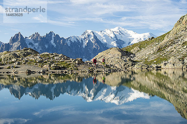 Wanderer und der Gipfel des Mont Blanc  der sich im Lac Blanc spiegelt  auf der Trekkingroute Tour du Mont Blanc in den französischen Alpen  Haute Savoie  Auvergne-Rhone-Alpes  Frankreich