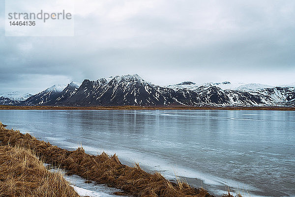 Blick auf die Berge von Snaefellsnes auf der Halbinsel früh am Morgen mit gefrierendem Wasser im Vordergrund  Island  Polarregionen