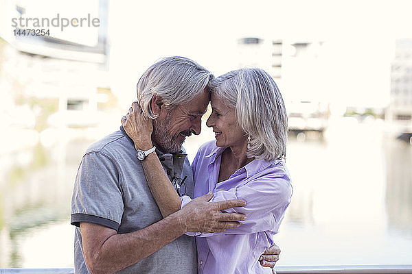 Älteres Ehepaar macht eine Städtereise  küsst und umarmt sich