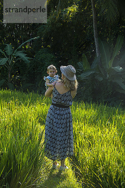 Indonesien  Bali  Ubud  Frau mit ihrem kleinen Mädchen in den Reisfeldern