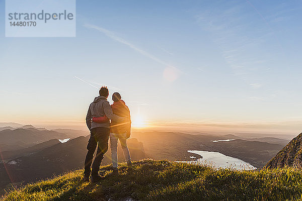 Österreich  Salzkammergut  Ehepaar steht auf Berggipfel  genießt die Aussicht