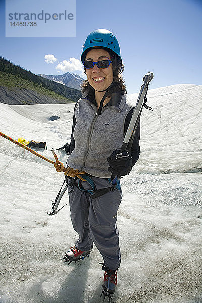 Frau bereitet sich auf den Aufstieg in die Gletschermühle auf dem Root Glacier in der Nähe von Kennicott in Süd-Zentral-Alaska vor Sommer