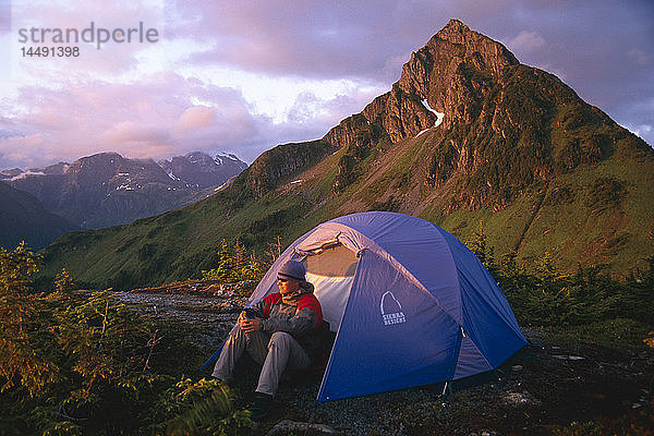 Man Sitting Outside Tent @ Campingplatz in Evening Coast Mtns Southeast Alaska Sommer