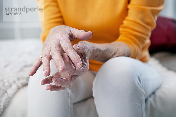 Ältere Frau mit Handschmerzen.