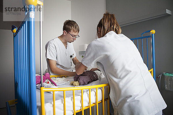 Reportage aus der pädiatrischen Notaufnahme eines Krankenhauses in Haute-Savoie  Frankreich. Eine Krankenschwester und eine Hilfskraft nehmen einem Baby eine Blutprobe ab.