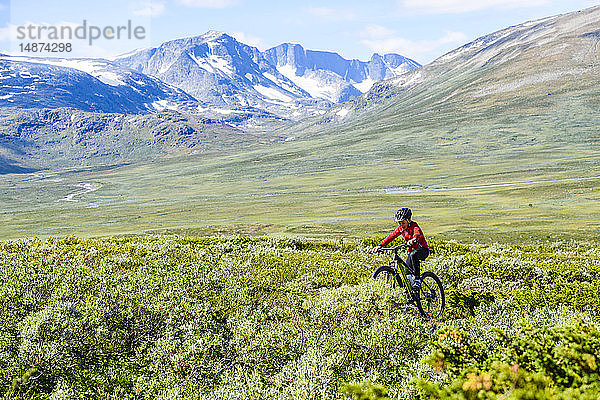 Junge fährt Fahrrad in den Bergen