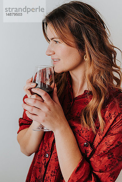 Frau hält ein Glas Wein  weißer Hintergrund