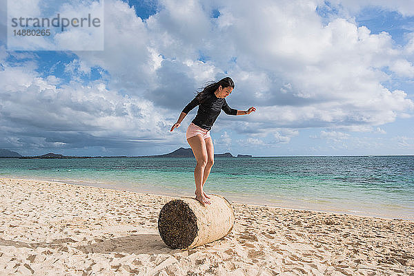 Frau balanciert auf Grasrolle  Lanikai Beach  Oahu  Hawaii