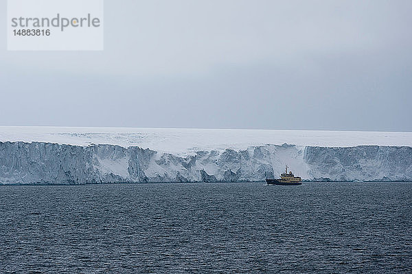 Schiff passiert Eisklippen der Polkappe  Austfonna Nordaustlandet  Svalbard  Norwegen
