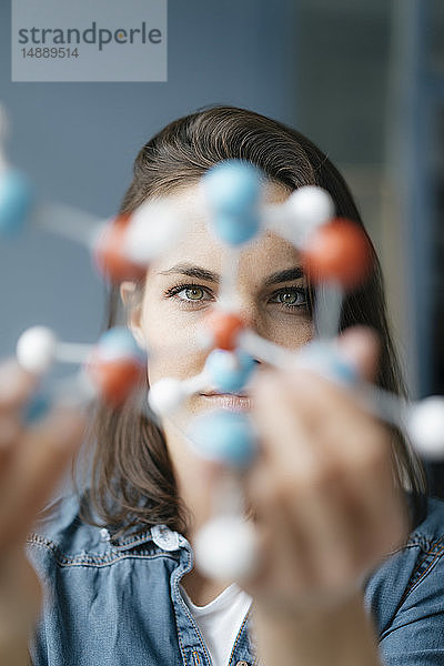 Weibliche Wissenschaftlerin untersucht Molekülmodell  sucht nach Lösungen