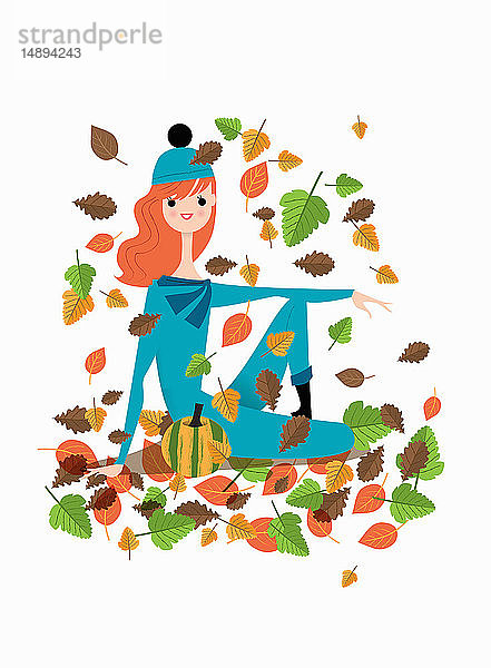 Junge Frau sitzt im Herbstlaub