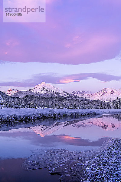Das Alpenglühen färbt die schneebedeckten Küstenberge  der Mendenhall-Gletscher und die Mendenhall-Türme spiegeln sich im offenen Wasser am Rande des Auke Lake  während die Sonne untergeht; Alaska  Vereinigte Staaten von Amerika
