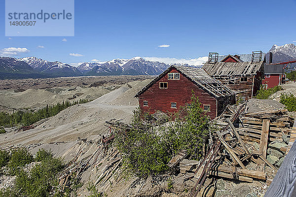 Gebäude der Kennicott-Mine mit der Moräne des Root-Gletschers und den Wrangell-Bergen im Hintergrund im Wrangell-St. Elias-Nationalpark und -Schutzgebiet  Süd-Zentral-Alaska; Alaska  Vereinigte Staaten von Amerika