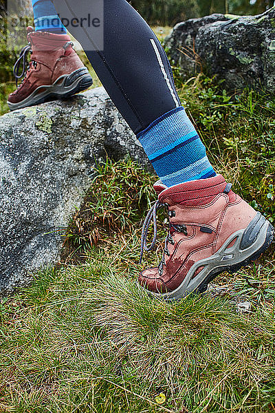 Wanderin beim Betreten eines Felsens  Nahaufnahme der Wanderschuhe