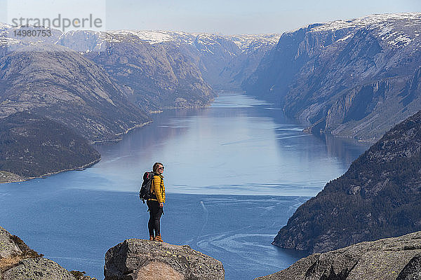 Wanderer  der die Aussicht auf die Klippen genießt  Preikestolen (Kanzelfelsen)  Lysefjord  Norwegen  Stavanger