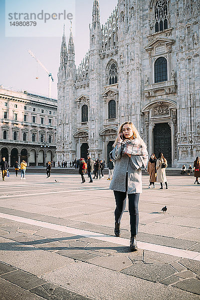 Junge Touristin telefoniert mit ihrem Smartphone am Mailänder Dom  Mailand  Italien