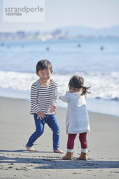 Japanische Kinder am Strand