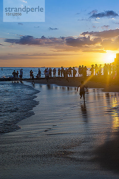 Hawaii  Oahu  Strand von Waikiki  Touristen  die den Sonnenuntergang beobachten