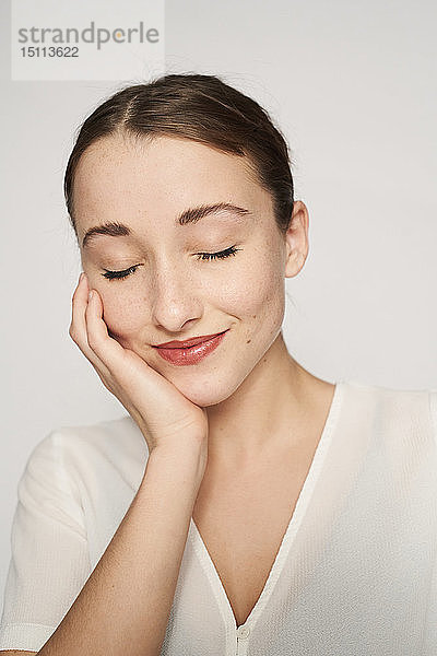 Bildnis einer lächelnden jungen Frau mit Kopf in der Hand und geschlossenen Augen