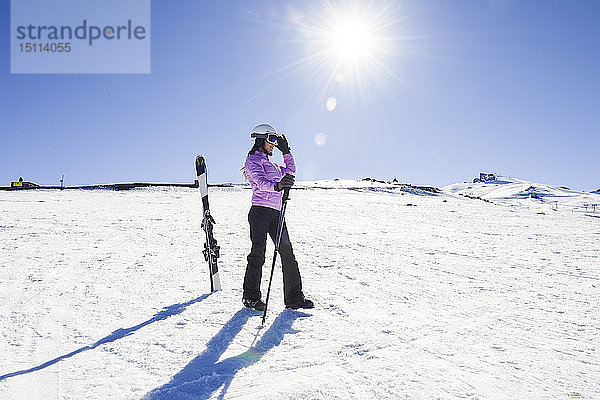 Frau in Skikleidung bereitet sich in der Sierra Nevada  Andalusien  Spanien  auf das Skifahren vor