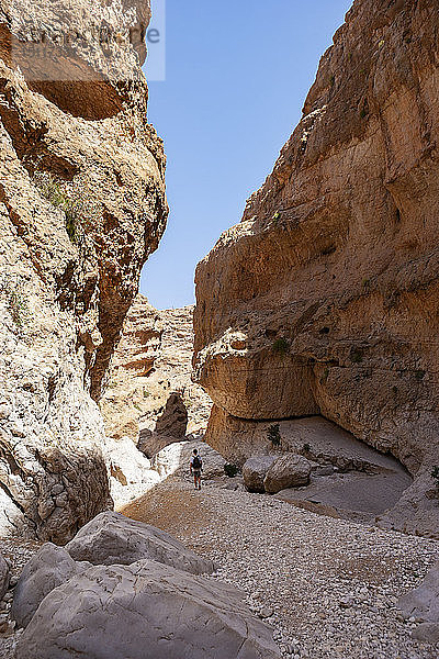 Mann geht durch Felsen  Wadi Bani Khalid  Oman