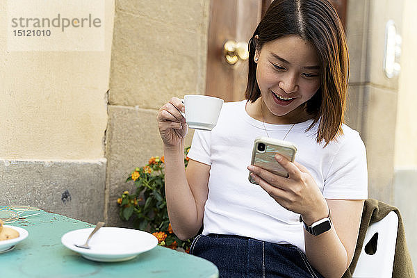 Italien  Florenz  junge Frau telefoniert in einem Café im Freien