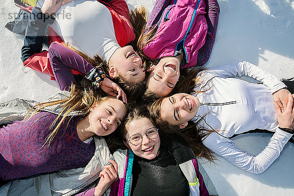 Fünf jugendliche Skifahrerinnen liegen im Kreis im Schnee  Draufsicht  Tirol  Steiermark  Österreich