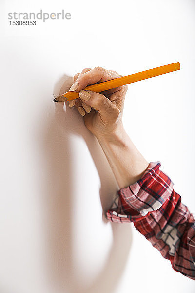 Markierung einer Frau mit Bleistift an einer Wand