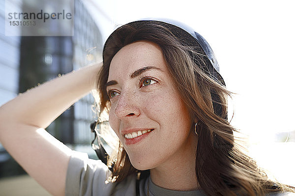 Frau mit schwarzem Helm seitlich schauend