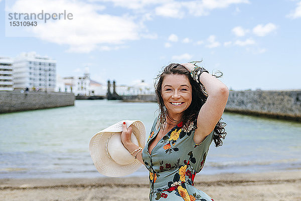 Frau mit weißem Sonnenhut im Hafen von Arrecife  Spanien