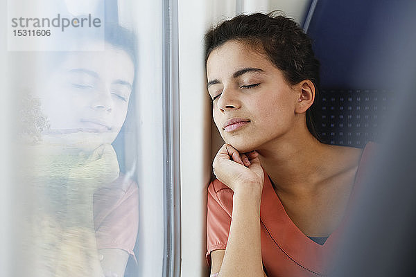 Teenagerin allein im Zug unterwegs  schlafend