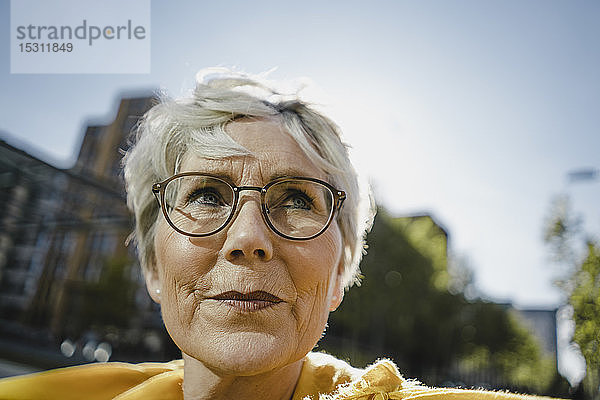 Bildnis einer reifen Frau mit kurzen grauen Haaren und Brille