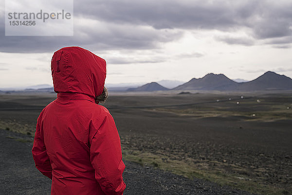 Junge Frau mit Blick auf das Hochland  Island