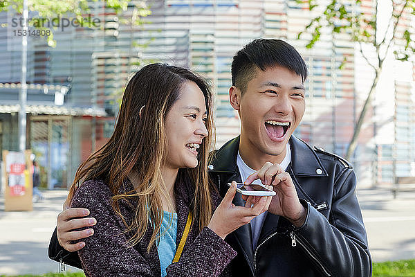 Glückliches Paar schickt eine Sprachnachricht mit dem Handy  Barcelona  Spanien