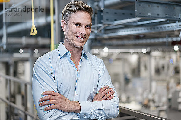 Porträt eines selbstbewussten Geschäftsmannes in einer Fabrik