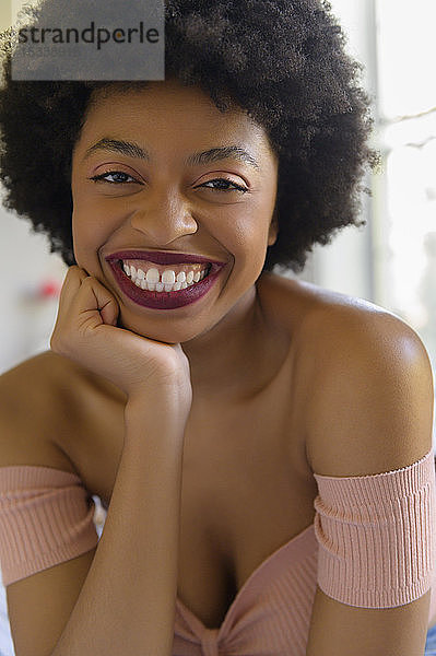 Porträt einer lächelnden jungen Frau mit Lippenstift