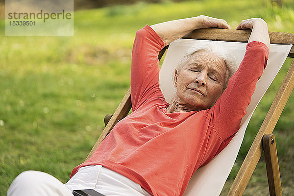 Ältere Frau entspannt sich auf einem Stuhl