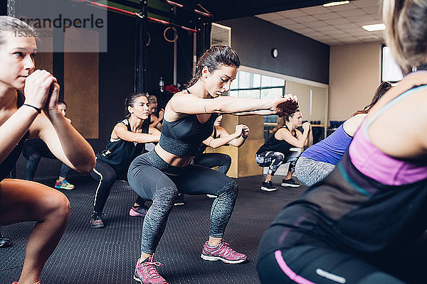 Gruppe von Frauen  die im Fitnessstudio trainieren  hockend