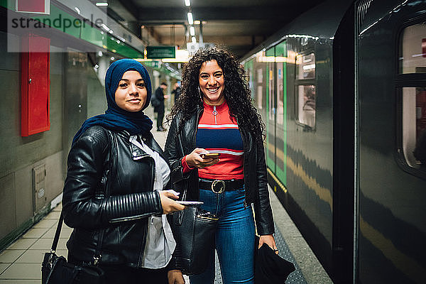 Junge Frau im Hidschab mit Freundin in der U-Bahn-Station  Porträt