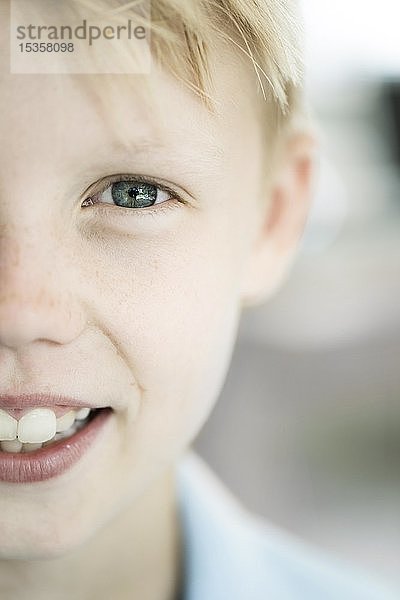 Junge  10 Jahre  blond  schaut in die Kamera  lächelt  Portrait  Gesichtsausschnitt  blaue Augen  Deutschland  Europa