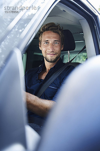 Porträt eines selbstbewussten jungen Mannes im Auto