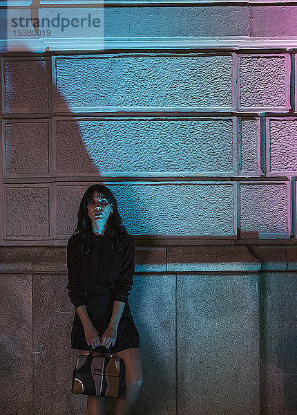 Junge Frau in der Stadt bei Nacht