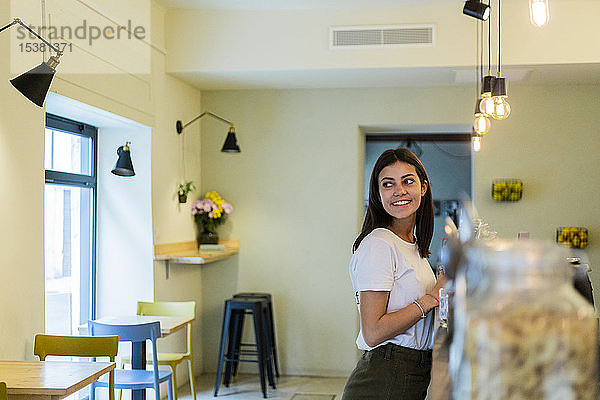 Lächelnde junge Frau in einem Cafe