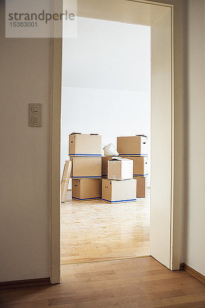 Pappkartons in einem leeren Raum in einem neuen Zuhause