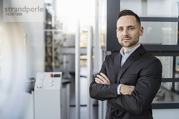 Porträt eines selbstbewussten Geschäftsmannes in einer modernen Fabrik