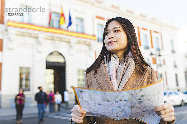 Spanien  Madrid  junge Frau mit Stadtplan  die die Stadt erkundet