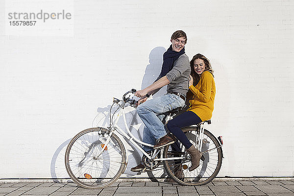 Deutschland  Bayern  München  Junges Paar auf dem Fahrrad  lächelnd