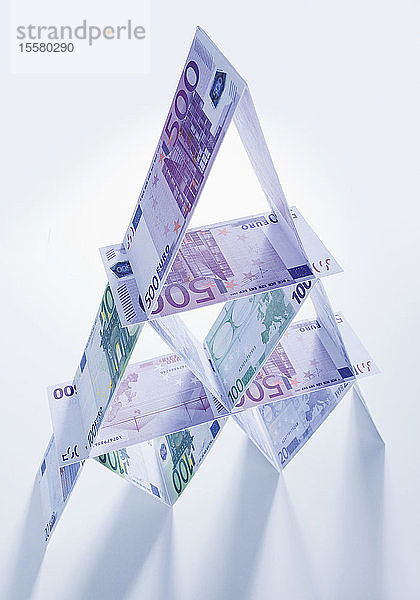 Kartenhaus bestehend aus Euro-Banknoten auf weissem Hintergrund