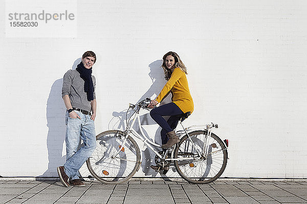 Deutschland  Bayern  München  Junges Paar mit Fahrrad  lächelnd  Portrait
